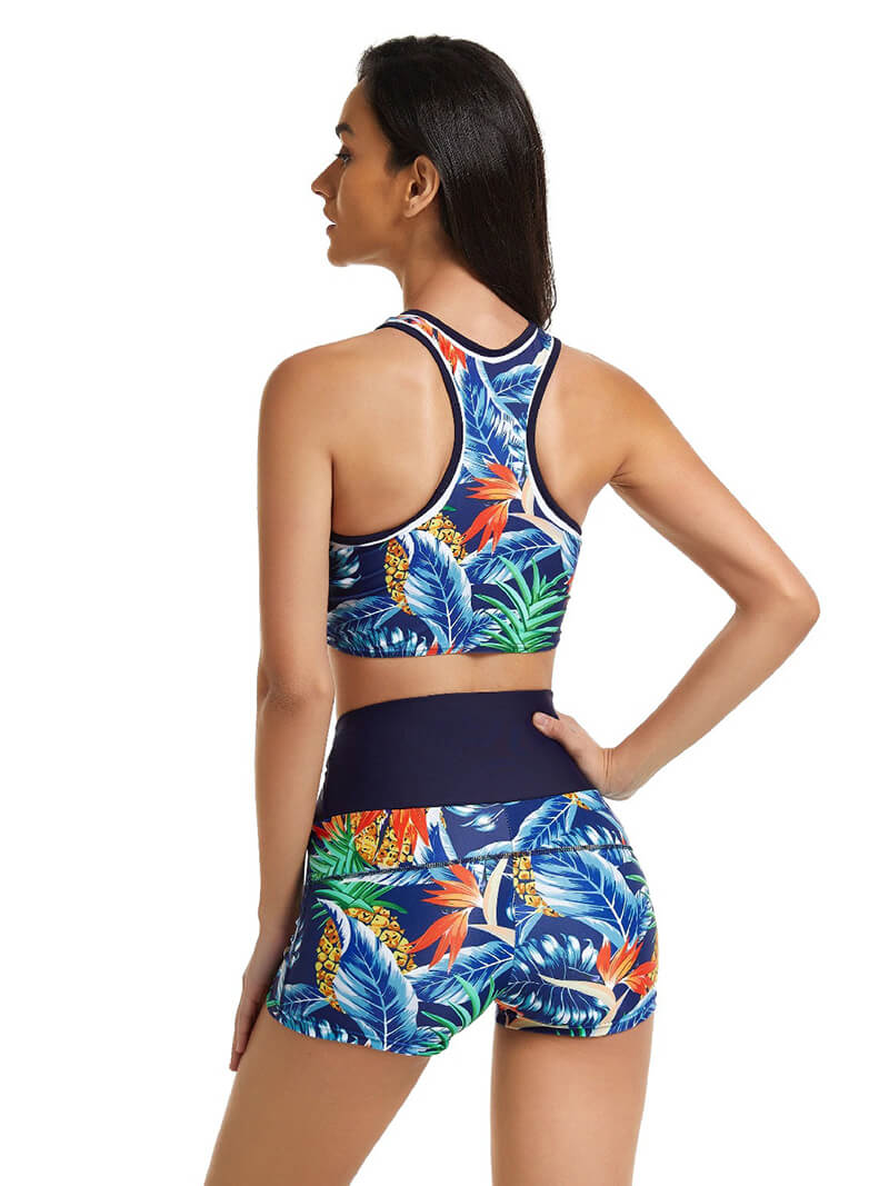 Back view of a woman wearing a floral Sexy Sports Ladies Two Piece Swimsuit, perfect for beach fitness activities.